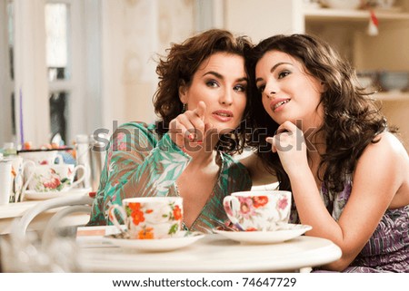 stock photo : Lovely women drinking her tea while chatting. See more images from the same shoot.