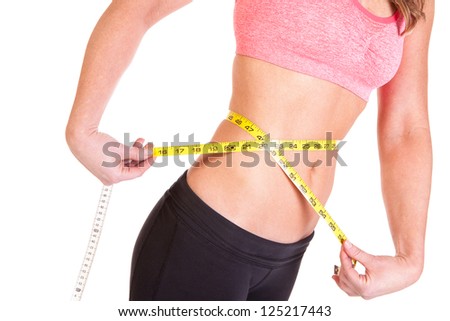 woman using a tape measure to measure her waist size
