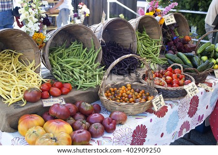 Tomatoes,beans,cucumbers, and beats for sale at a farmers market.