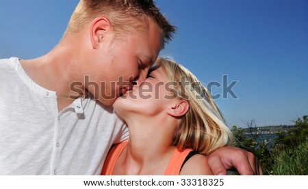 Young couple kissing in the sun