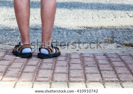 Funny feet covered with socks and sandals