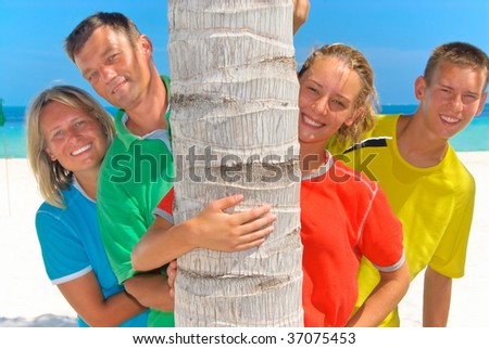 Family behind palm tree