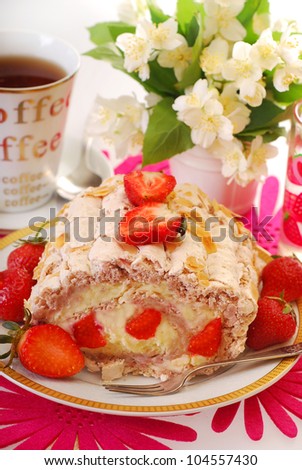 delicious cake-meringue swiss roll with whipped cream,fresh strawberry and almonds
