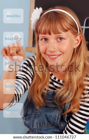 cute schoolgirl choosing school subjects pushing finger on virtual bottons