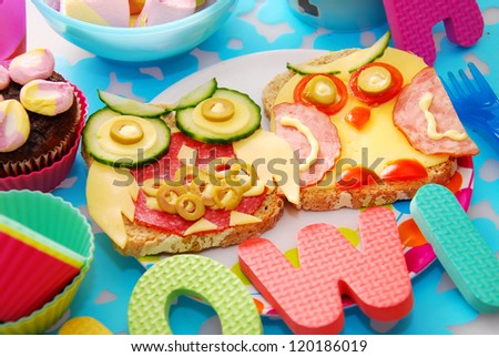 funny sandwiches with owl made from cheese ,sausage and vegetables for child