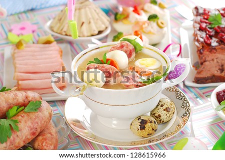 easter white borsht (zurek) in cup with quail eggs and white sausage bamboo stick and other traditional dishes