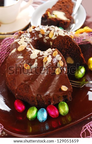 dark chocolate ring cake with almonds and nuts topping for easter