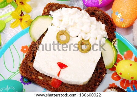 funny easter sandwich with sheep head made from cottage cheese on dark bread as breakfast for child