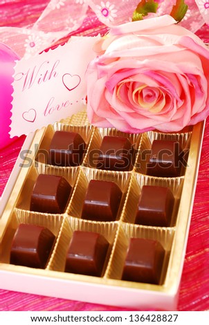 box of chocolates  and pink rose with greeting card