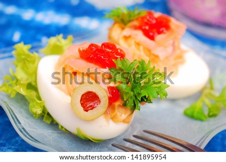 eggs stuffed with smoked salmon and red caviar as appetizer