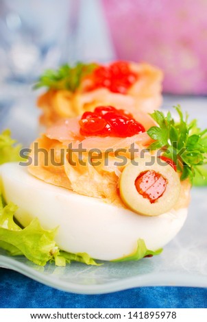 eggs stuffed with smoked salmon and red caviar as appetizer