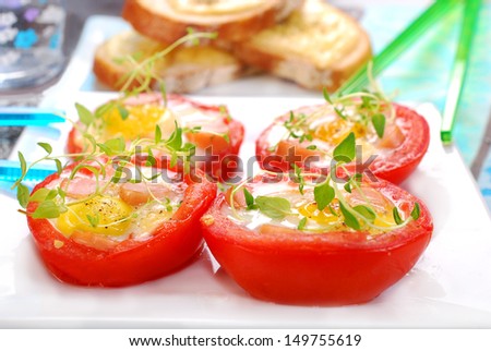 baked tomato halves stuffed with quail eggs and sausage