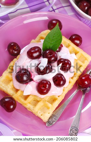 waffles with yogurt and fresh sour cherries for dessert