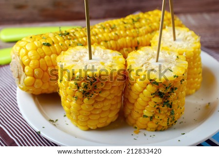 boiled sweet corn cobs with butter and herbs