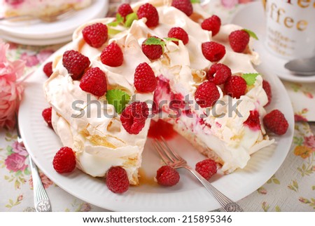 meringue  pavlova cake with whipped cream,caramel and fresh raspberries