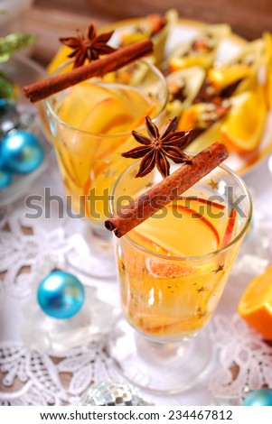 glasses of apple and orange drink with cinnamon and anise on christmas table
