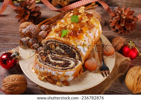 poppy seed cake with nuts and dried fruits for christmas on rustic wooden table