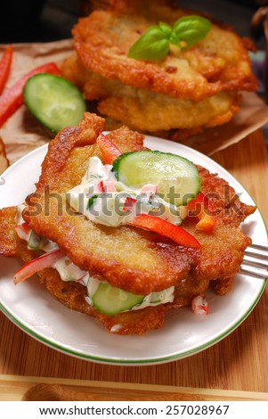 homemade fried potato cakes with vegetable and mayonnaise sauce