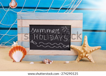 seaside background and marine wooden frame with chalk written text on blackboard standing on beach sand