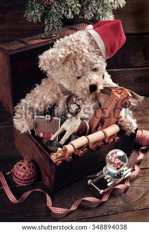 vintage christmas teddy bear and other toys for boys in old treasure chest