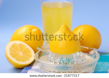 fresh lemon juice squeezed in glass squeezer