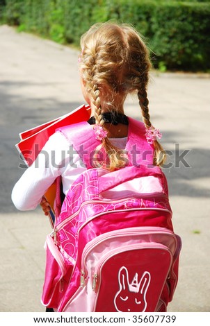 young girl with pink  backpack going to school