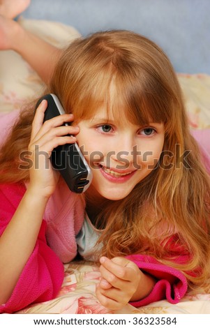 young girl talking by phone on the bed