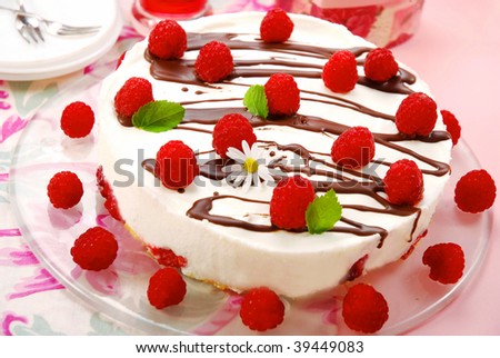 raspberry cake decorated with fresh fruits and melissa leaves