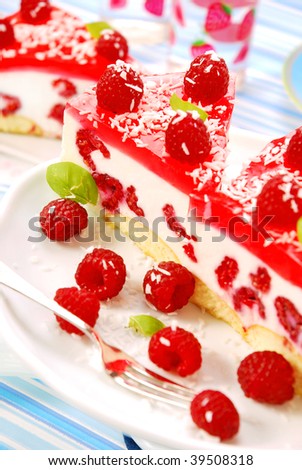 unbaked cheese cake with jelly and raspberry
