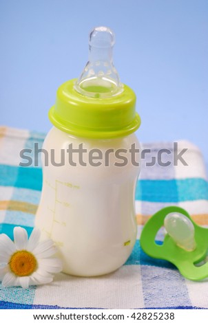 bottle of milk for baby on blue background