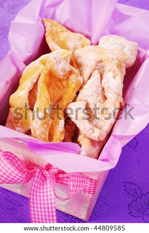 deep-fried pastries with icing sugar in gift box