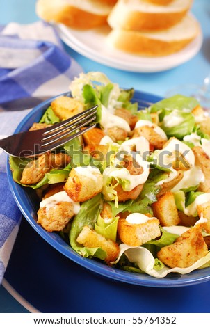 bowl of caesar salad with lettuce,grilled chicken and croutons
