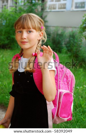 young girl with pink backpack going to school and waving hand to her parents