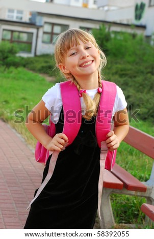 happy young girl with pink backpack going to school