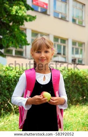 young girl with pink backpack going to school