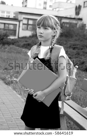 young girl with  backpack going to school -black and white image