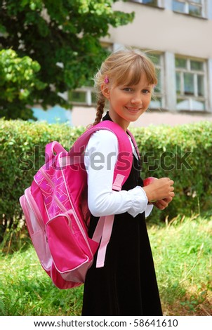 young girl with pink backpack going to school
