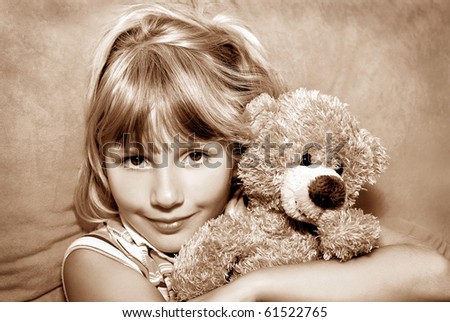 portrait of young girl with her teddy bear in vintage style (sepia)
