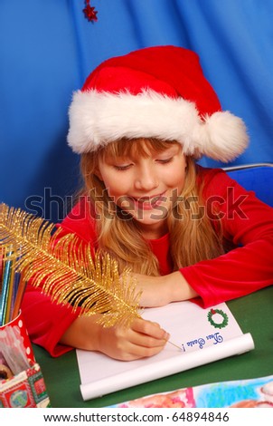 young girl in santa`s hat writing a letter to santa  by golden feather pen
