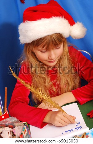 young girl in santa`s hat writing a letter to santa  by golden feather pen