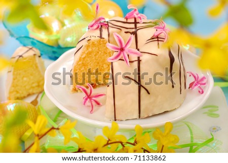 almond ring cake poured white and dark chocolate on easter table