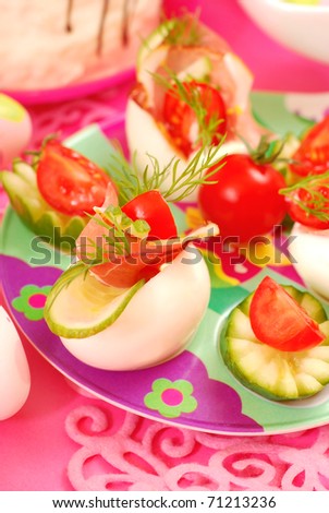 eggs stuffed with parma ham,cucumber,tomato and mayonnaise as appetizer for easter