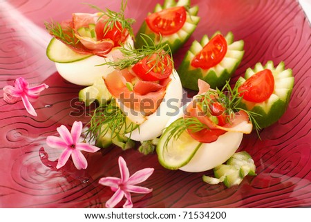 eggs stuffed with parma ham,cucumber,tomato and mayonnaise as appetizer for easter