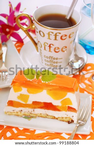portion of peach cake with jelly layers and coffee