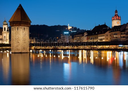 LUZERN, SWITZERLAND - SEPTEMBER 8: Chapel Bridge on September 8, 2012 in Luzern. Constructed in 14th centure, it was restored in 2002 after the fire which broke out at the night of August 17, 1993.