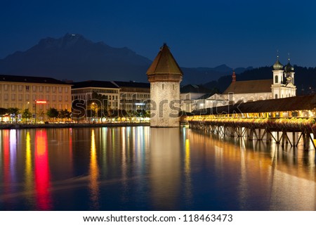 LUZERN, SWITZERLAND - SEPTEMBER 8: Chapel Bridge at dark night on September 8, 2012 in Luzern. The bridge was restored in 2002 after the terrible fire which broke out at the night of August 17, 1993.