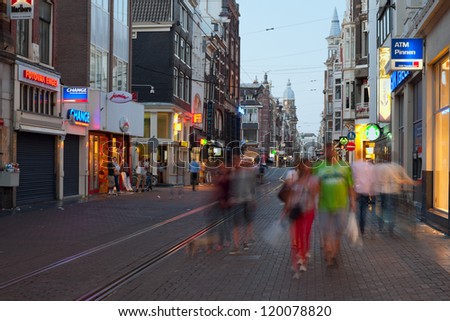 AMSTERDAM, NETHERLANDS - MAY 27: People are enjoying evening city center on May 27, 2012 in Amsterdam. Amsterdam is the country\'s largest city and visited with over 3,5 million foreign visitors a year