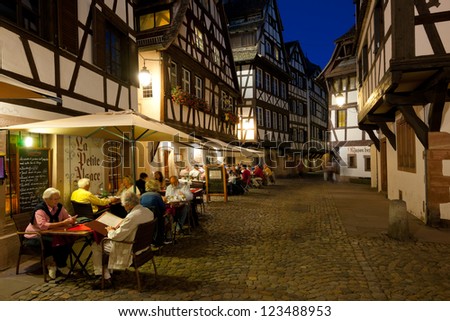 STRASBOURG, FRANCE - SEPTEMBER 16: People are sitting at cafes in Petite-France on September 16, 2012 in Strasbourg. Petite-France is an historic area in the center of Strasbourg.