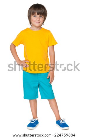 A young smiling boy in a yellow shirt on the white background