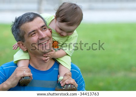 father and his little son are playing outside